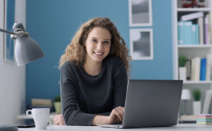 smiling woman at her desk