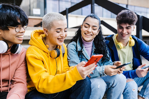 group of teens using phones